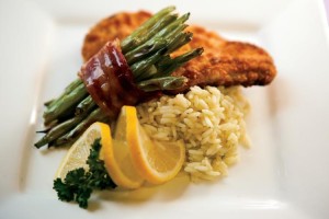 Parmesan crusted chicken breasts with bacon-wrapped green bean bundles and classic rice pilaf for quick-fix meals.