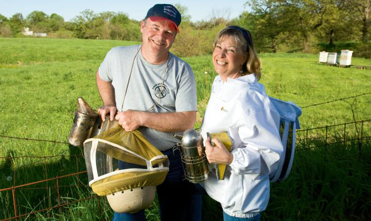 Dan and Janet Hart (members of Heart of Illinois Beekeepers Association) work with their bees at their home in Brimfield, Illinois.