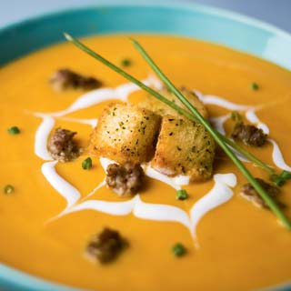 bowl of butternut squash soup with croutons