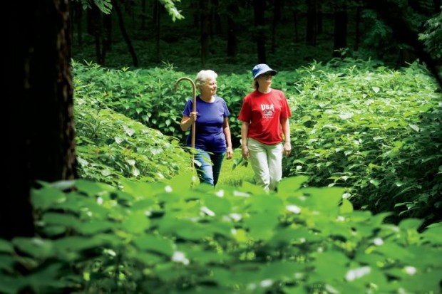 Dr. Peggy Lee, board member for Elkhart Historical Society(in Red) and Gillette M. Ransom (in purple), land owner on Elkhart hill walk on one of the many trails that cross the Hill.