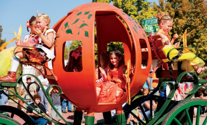 children in pumpkin-shaped carriage