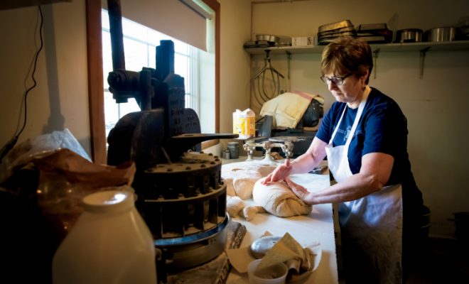 Owner Carol Brown of Nauvoo Mill & Bakery makes bread in the restaurant kitchen.