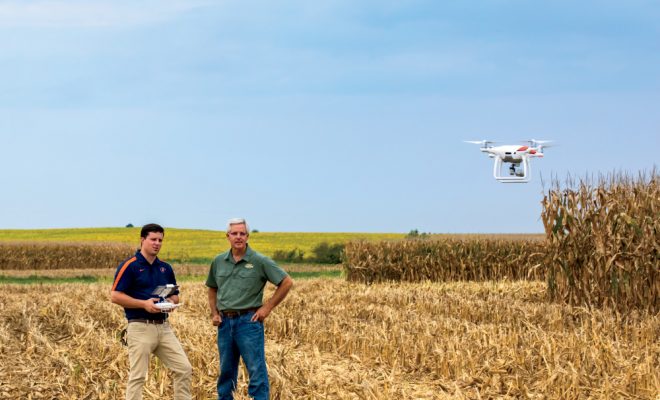 drone and farmers in Illinois cornfield