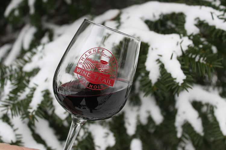 Shawnee Hills Wine Trail wine glass with snowy tree branch in background 