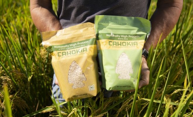 farmer holding High-Protein 'Cahokia' Rice