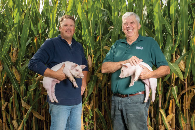 Randy Sims, right, and his son, Darren, grow corn and soybeans and care for pigs on their family farm in Liberty.