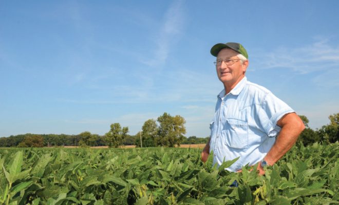 farmer standing in field of crops