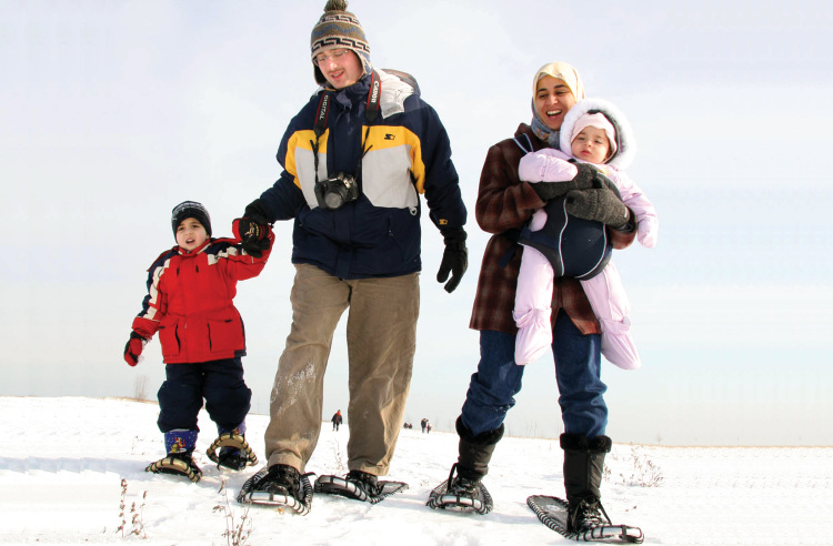 A family walking with snow shoes at Polar Adventure Days