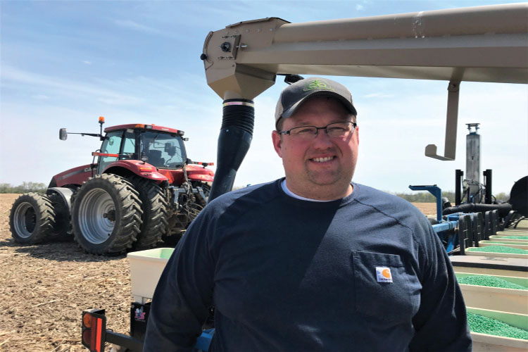 Andrew Murray in front of a farm equipment 