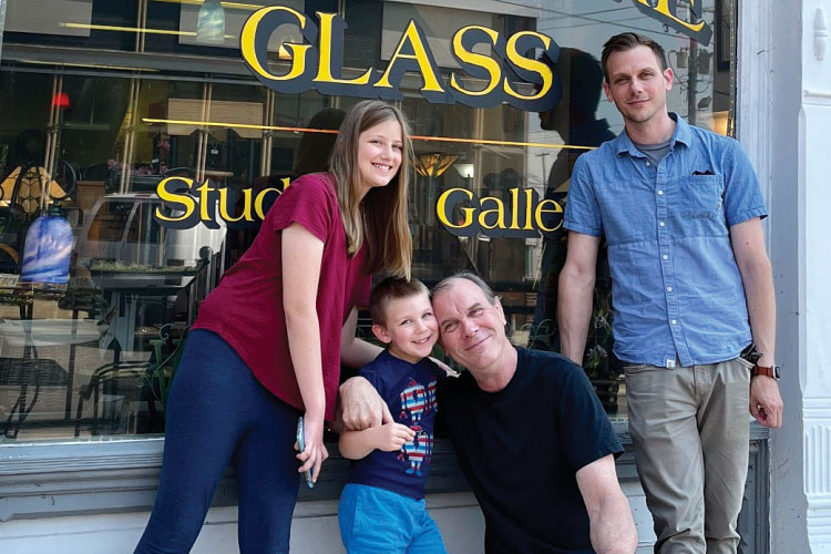 Jim Downey and his family outside Prairie Fire Glass in Monticello