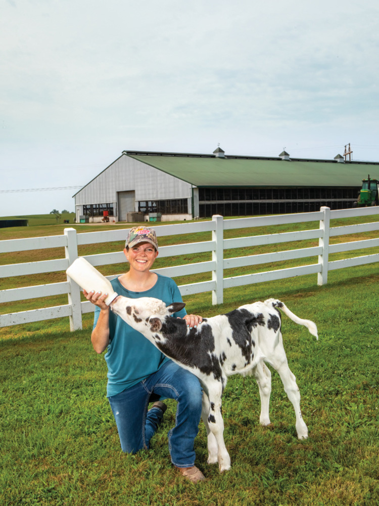 Leanne Casner bottle feeds a week-old calf