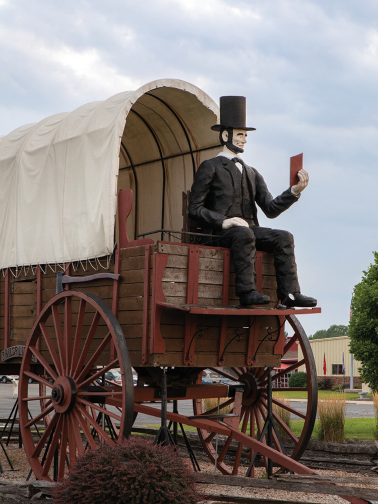 A large covered wagon with Abraham Lincoln