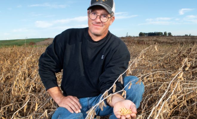 Dan Deering holding in his soybean field