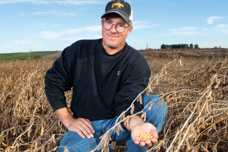 Dan Deering holding in his soybean field