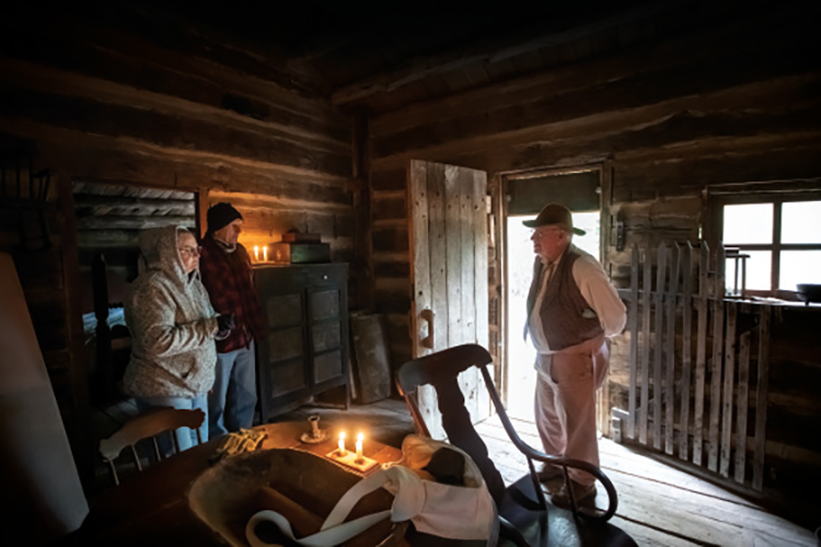 Visitors in the cabins at Lincoln's New Salem