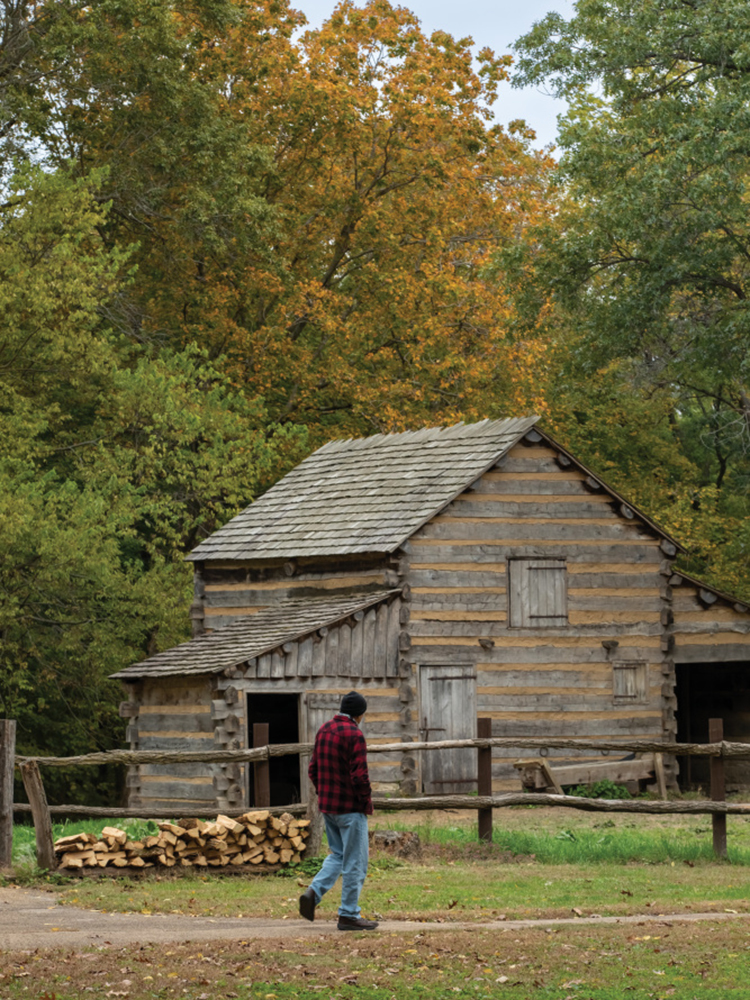 Visitors look at the cabins at Lincoln's New Salem