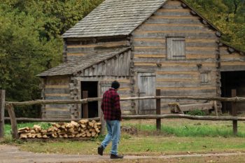 Visitors look at the cabins at Lincoln's New Salem
