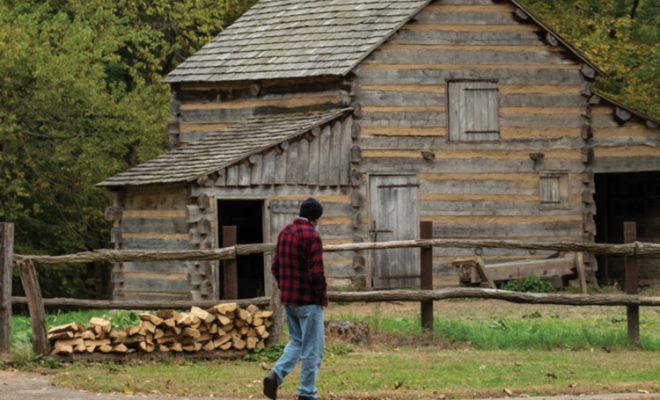 Visitors look at the cabins at Lincoln's New Salem
