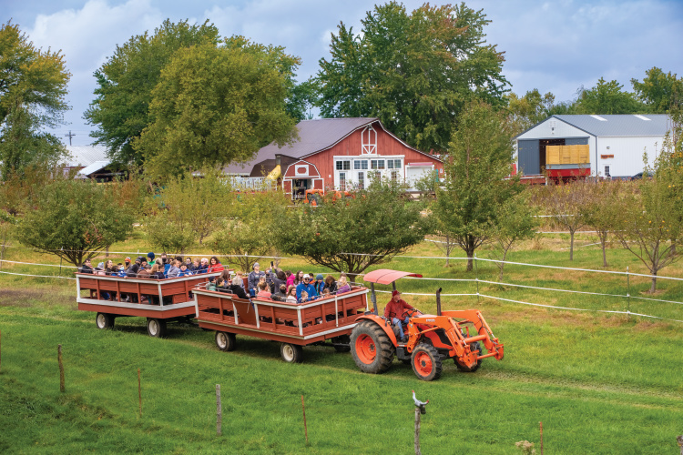 Visitors take a hay ride at the Indian Creek Farmstead