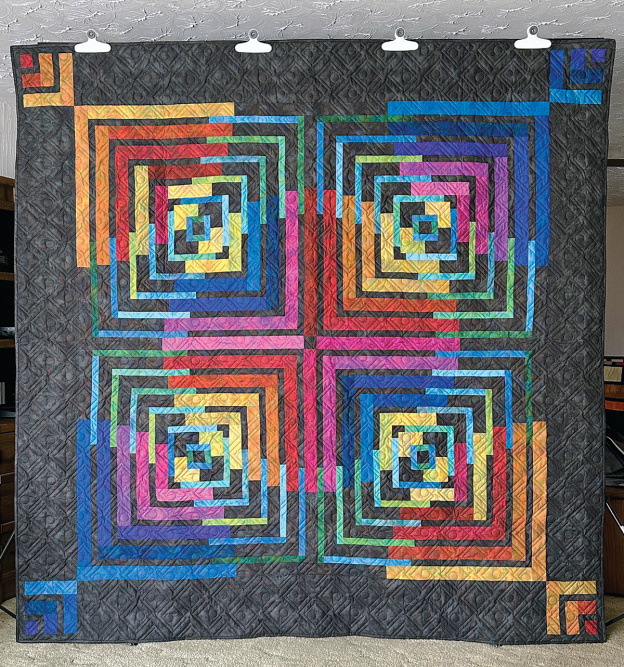 Quilt with a grey background and brightly colored background 