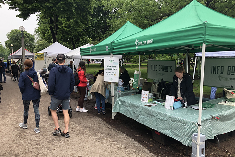 People walk through the Green City Market