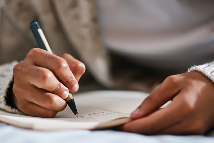 Someone writing in a journal