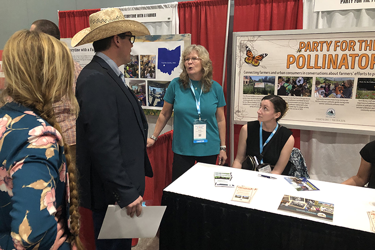Ruth Zeldenrust talking with AFBF convention attendees at the Party for Pollinators booth 