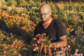 Drew Groezinger picking flowers at his flower farm, Clara Joyce Flowers