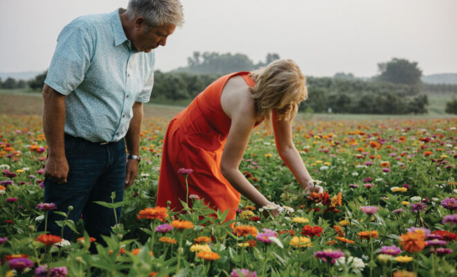 Wayne and Michelle Sirles pick flowers at their The Fields at Rendleman Orchards