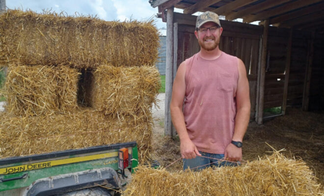 Josh Reinhardt loads square hay bales
