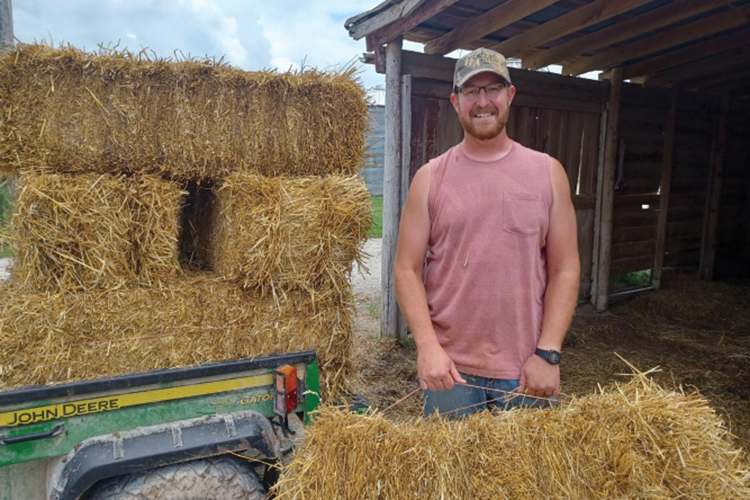 Josh Reinhardt loads square hay bales