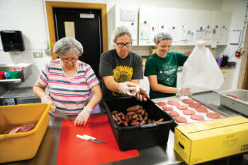 Cafeteria workers prep local food for school lunches as part of the farm-to-school program