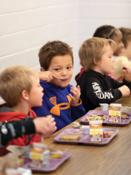 Elementary-age kids eating lunch in the cafeteria