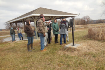 Visitors reading one of the signs at New Philadelphia