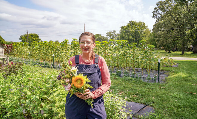 Natasha Lewis holds a bouquet of flowers at her farm
