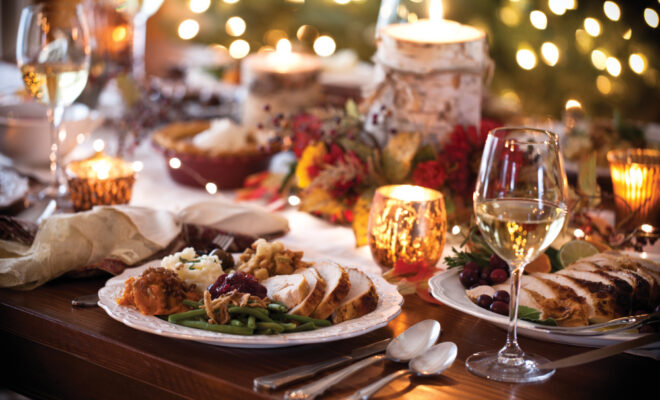 Holiday place setting with a plate full of turkey and side dishes