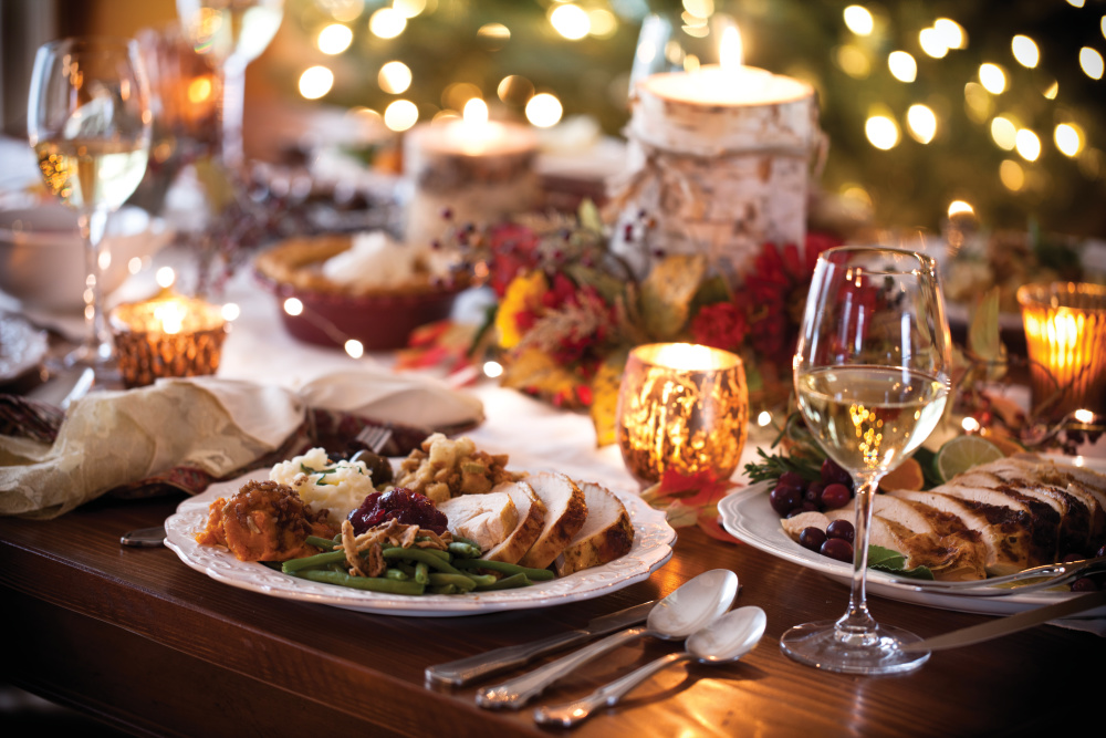 Holiday place setting with a plate full of turkey and side dishes; farmers gather for holiday meal