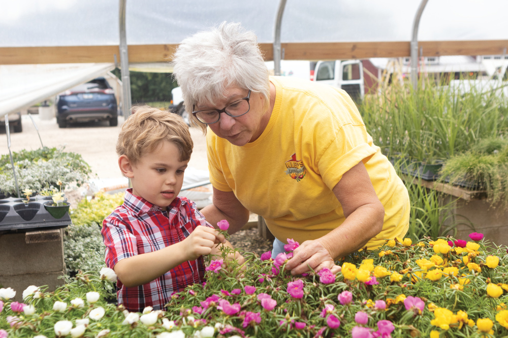 Chris Klein and her grandson, Henry, with some of the plants