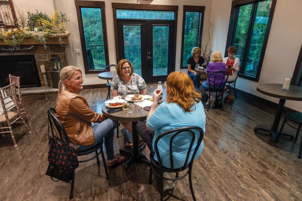 Three women sitting at a table at Irene's Vineyard