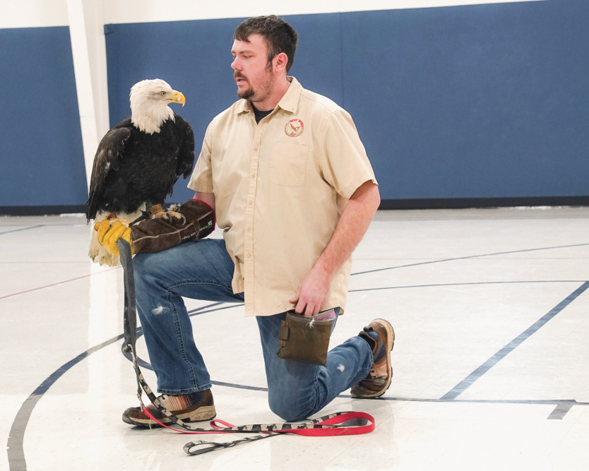 Men with an American Eagle resting on his arm at Bald Eagle Watch Weekend