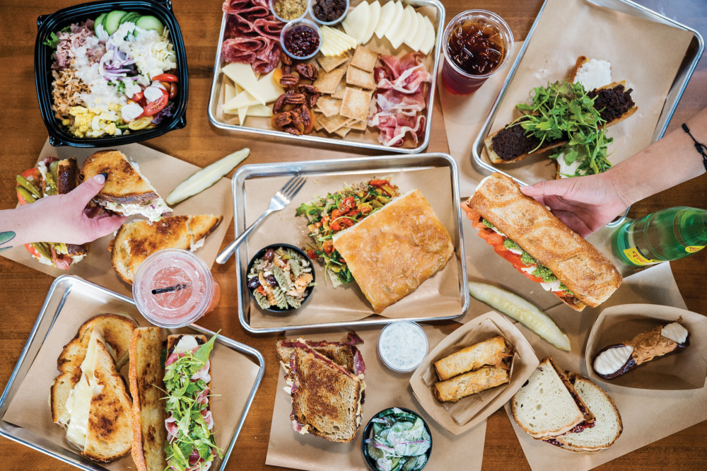 A bird's eye view of a table full of food at a restaurant 