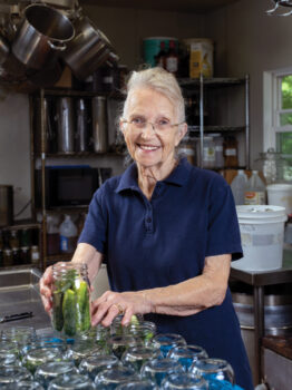 Kathy Keylor filling jars with pickles