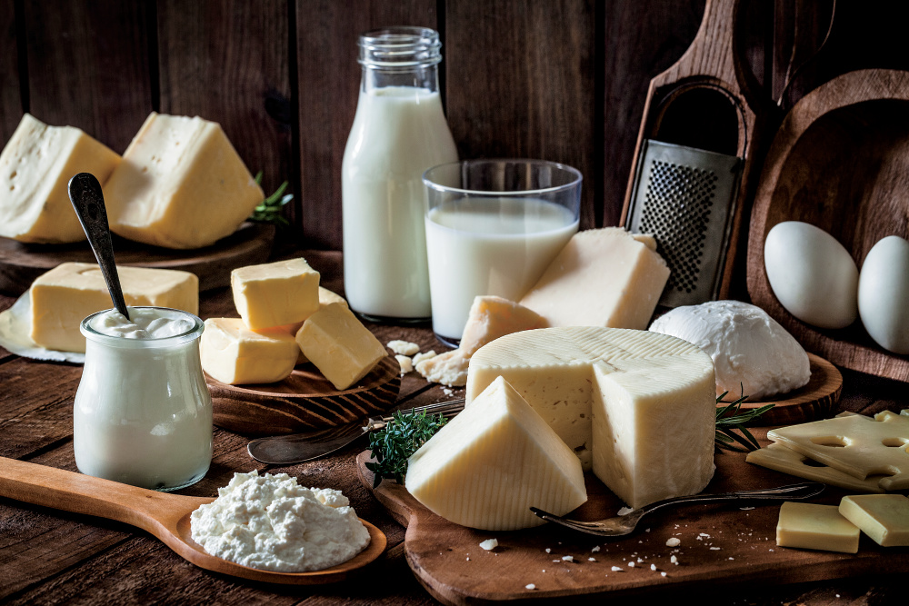 Dairy products including cheese, milk and more on a wooden table
