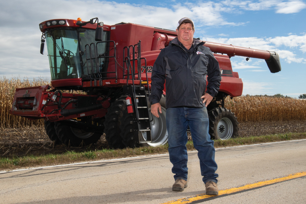 Dan Ziller, an advocate for sharing the road safey with farm equipment, stands in front of farm equipment 