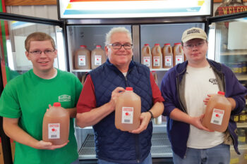Men holding jugs of cider at Edgewood Orchards