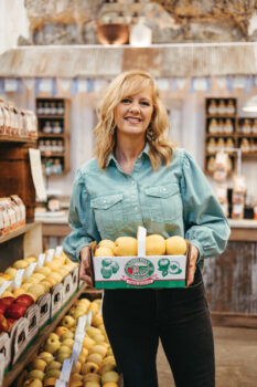 Michelle Sirles holds a box of apples at Rendleman Orchards 