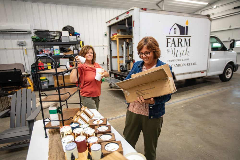 Amy Manahan and Alice Long sort candles and other items for Farm to Wick 