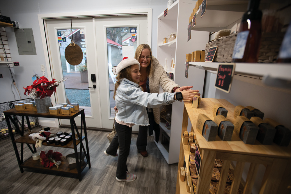 Mother and daughter shopping at Simply Kirious Soaps at the Boardwalk Shops in downtown Batavia