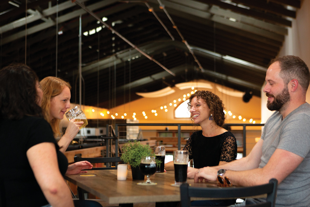 People drinking at table in Sturdy Shelter Brewing