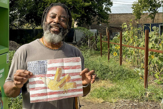 Steve Archer holds up a drawing he saved from a student in his wife’s classroom. The students drew pictures for Archer while he was deployed with the Marines in Iraq.